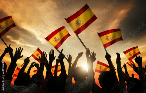 Silhouettes of People Holding Flag of Spain