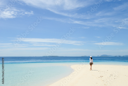 beautiful young girl looking at horizon on tropical beach