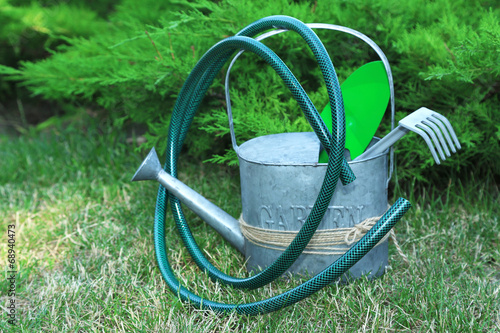 Garden tools on green grass background