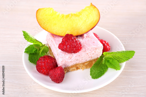 Fototapeta Naklejka Na Ścianę i Meble -  Cake with fruits and berries on plate on wooden background