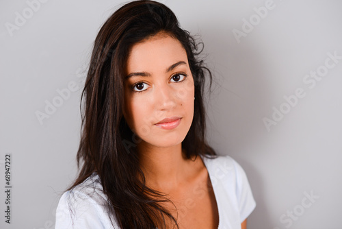 isolated studio shot of a beautiful and cheerful young brunette
