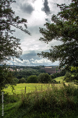 Looking through the trees to the Göltzsch Viaduct, the biggest stone bridge, man-made, of Europe in Netzschkau Germany