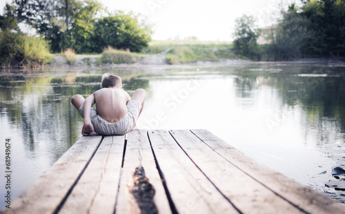 Boy sitting at the lake