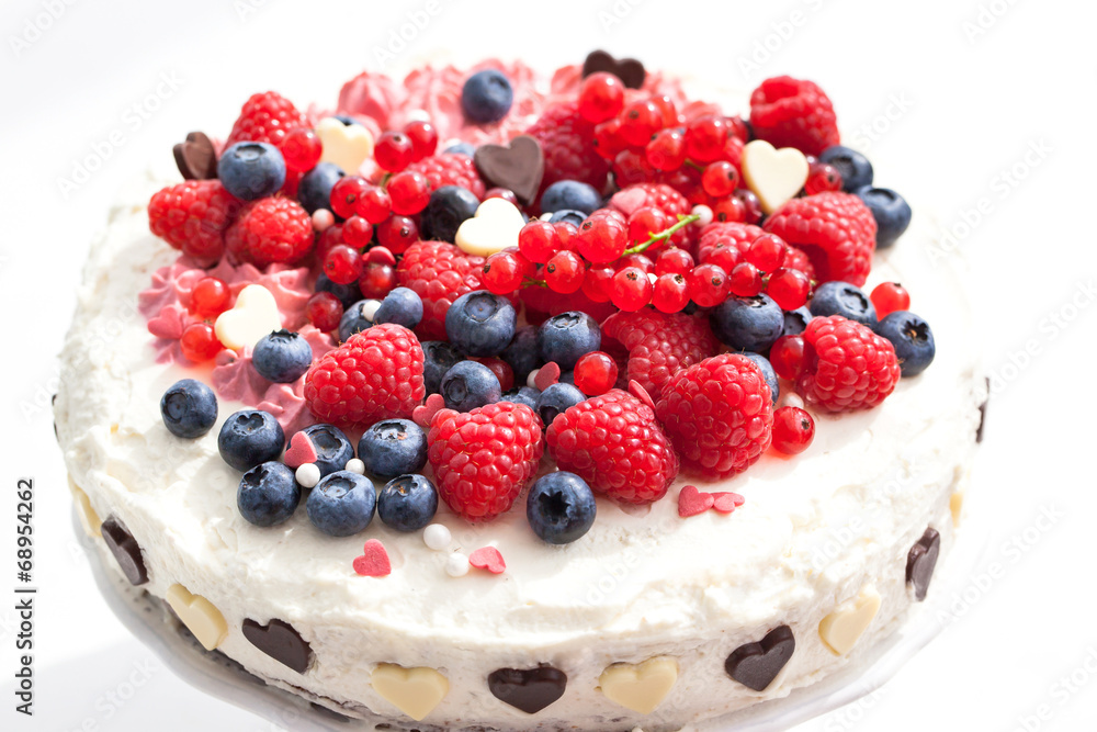Homemade creamy cake decorated with fresh berries Homemade creamy cake decorated with fresh berries