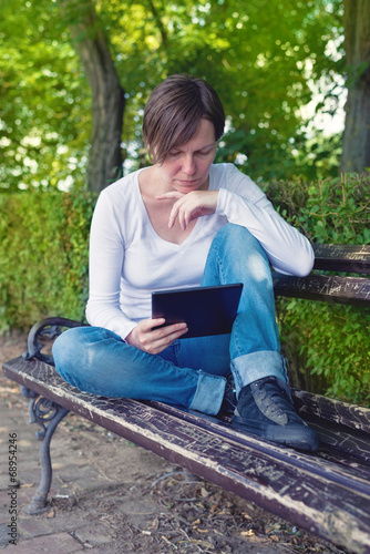 Woman reading E-book on digital tablet computer
