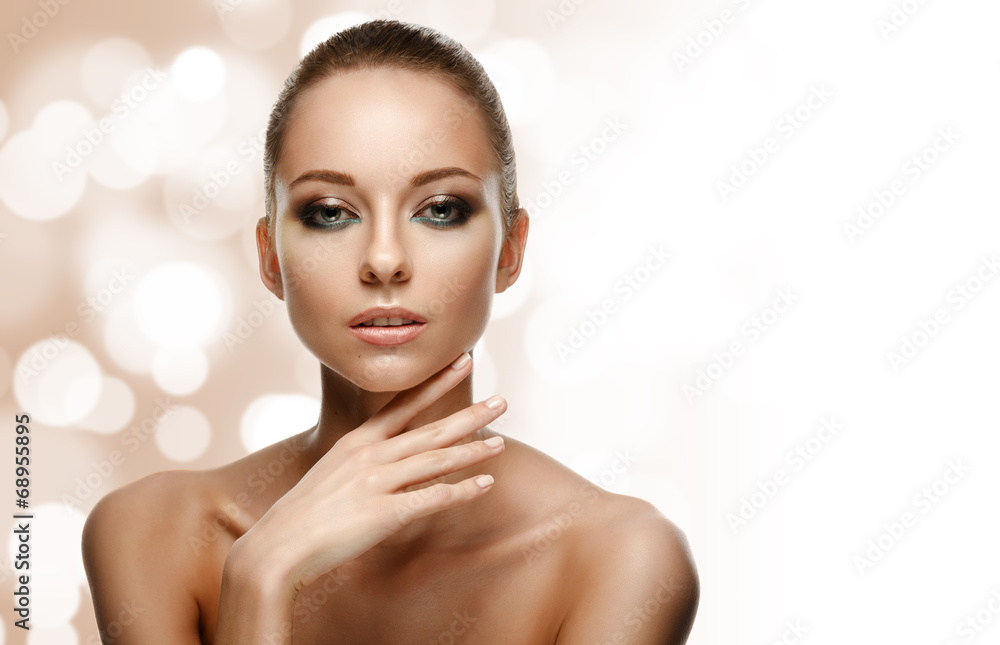 Naklejka premium Beauty Portrait. Beautiful Woman Touching her Face.