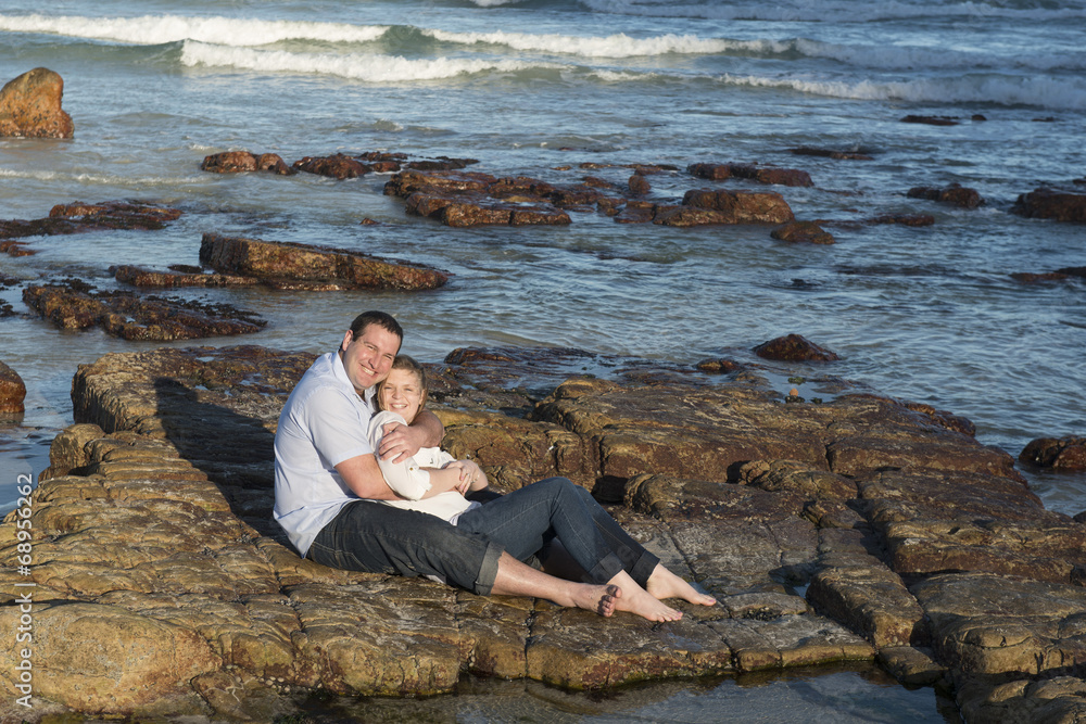 Couple sitting on a rock