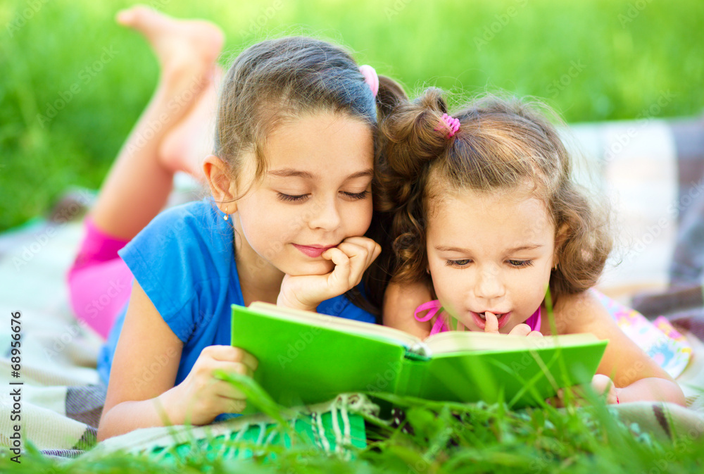Two little girls are reading book Two little girls are reading book