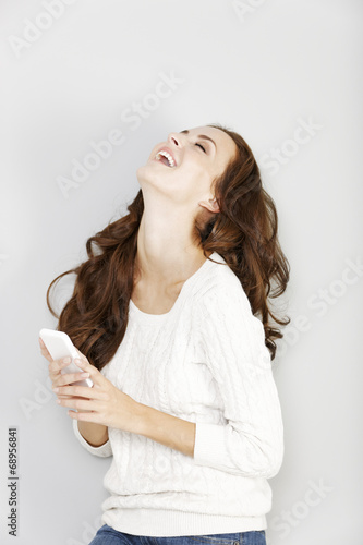 Woman laughing at her phone