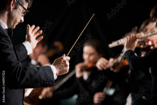 Tela Conductor directing symphony orchestra