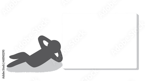 A lazy man lying down beside a whiteboard
