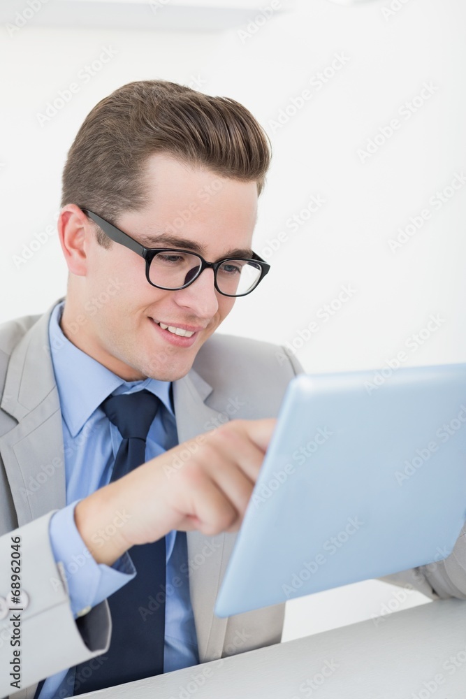 Nerdy businessman working on tablet pc Nerdy businessman working on tablet pc