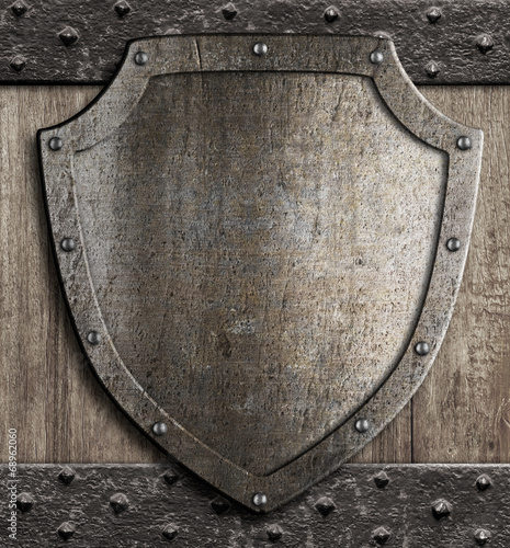medieval shield on wooden gate
