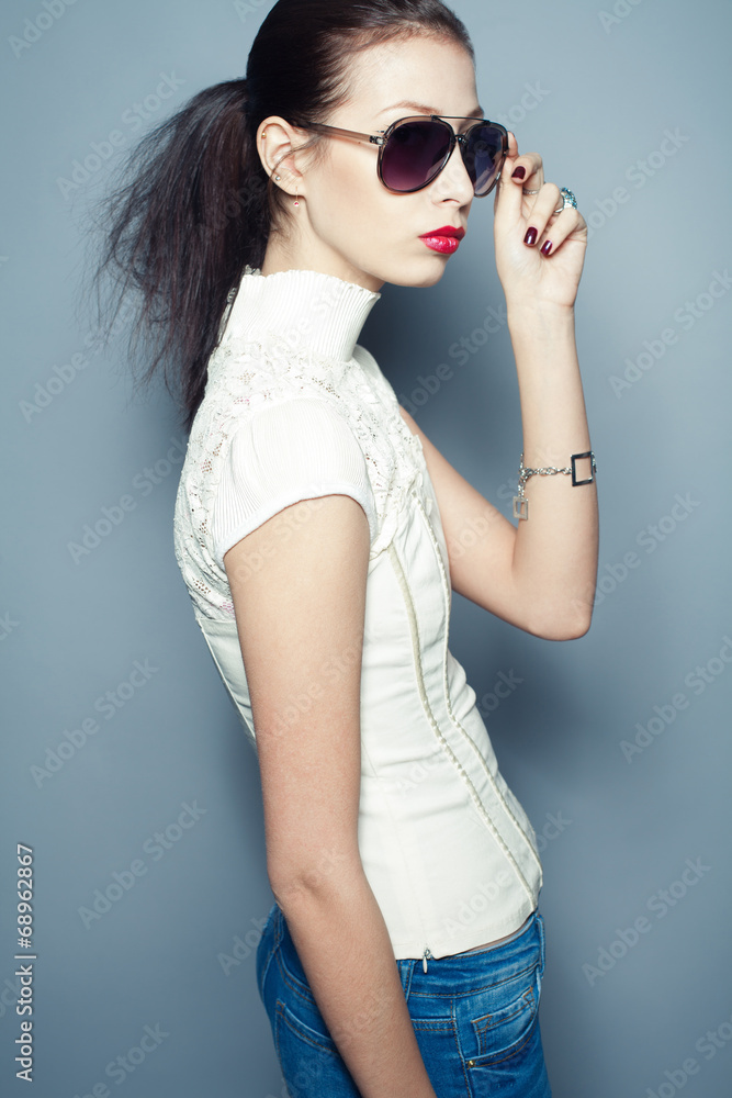 Eyewear concept. Fashionable beautiful young woman in sunglasses
