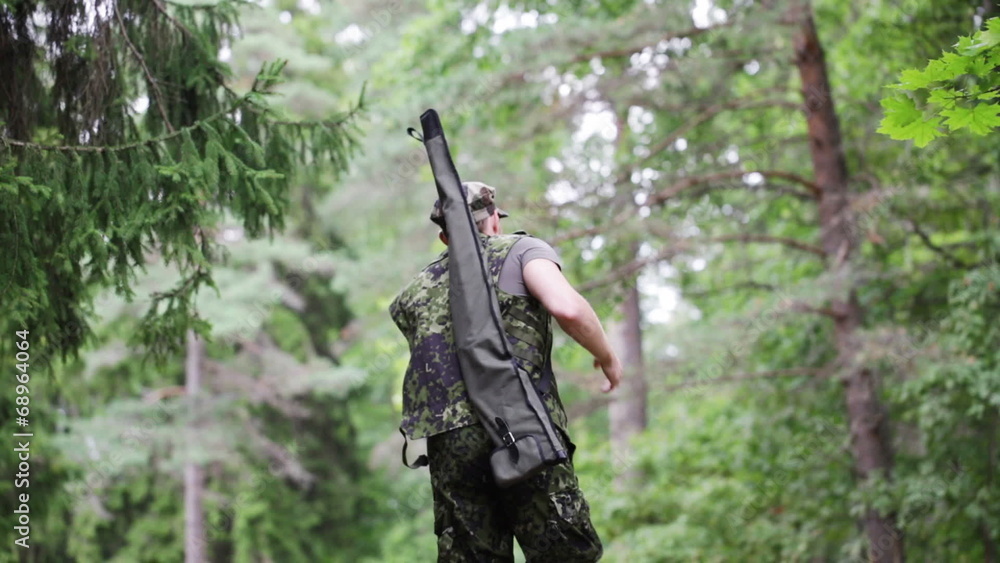 young soldier or hunter with gun in forest young soldier or hunter with gun in forest