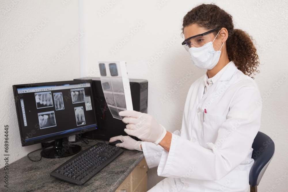 Dentist examining xrays on computer Dentist examining xrays on computer