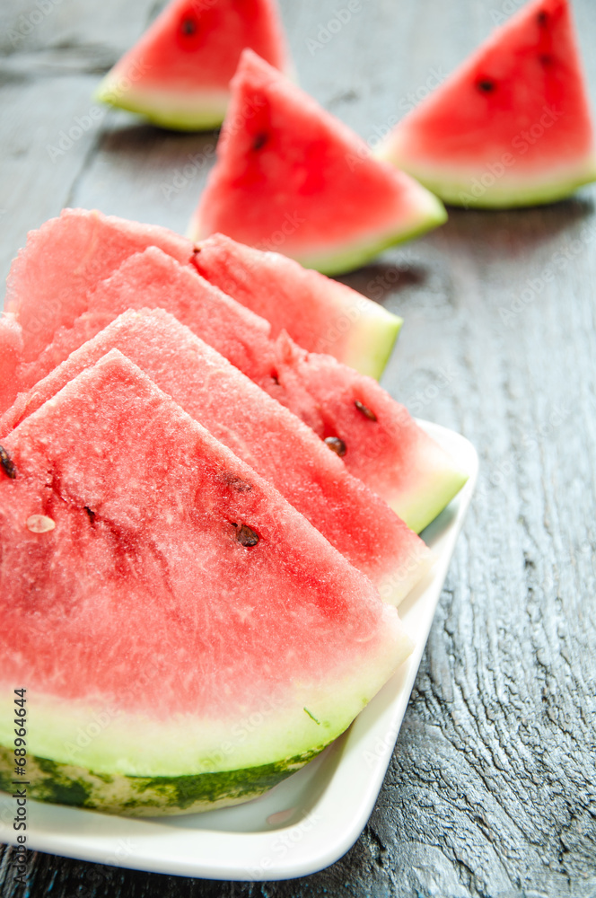 Ripe watermelons on table on the wooden background Ripe watermelons on table on the wooden background