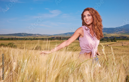 Happy woman  in golden wheat