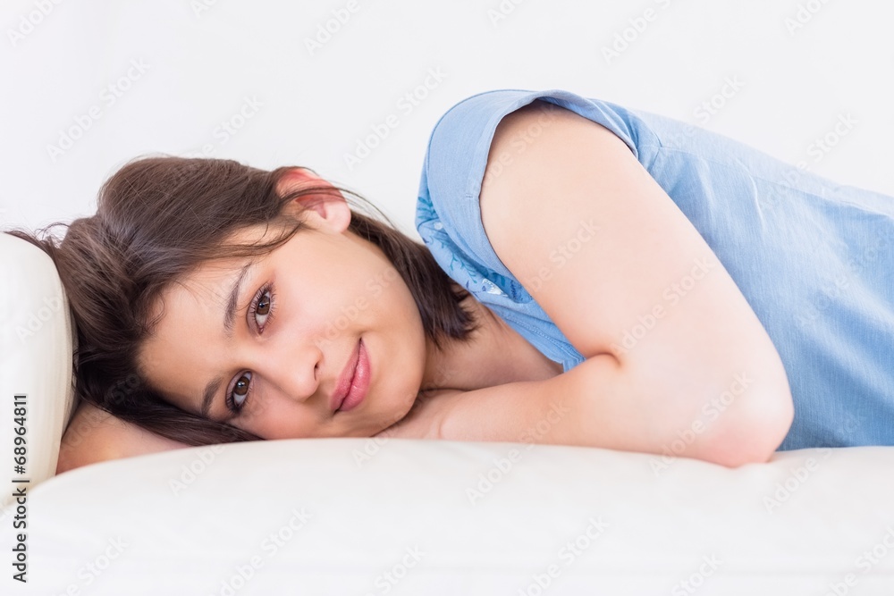 Pretty brunette smiling at camera on the couch Pretty brunette smiling at camera on the couch