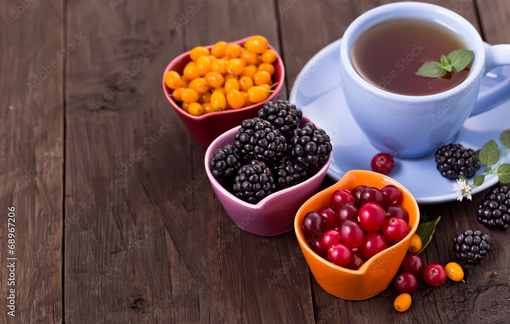 Various berries with cup of tea Various berries with cup of tea