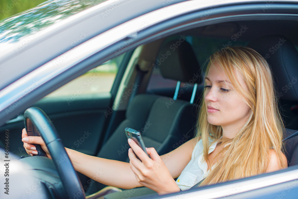 custom made wallpaper toronto digitalBeautiful young woman writing sms while driving car.