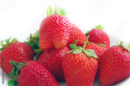 Three fresh strawberries isolated on white background.