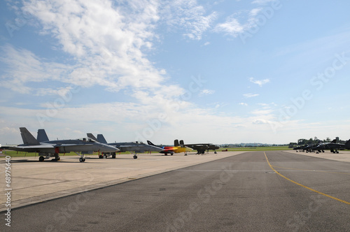 Miitary aircraft parked on the runway at an airshow photo