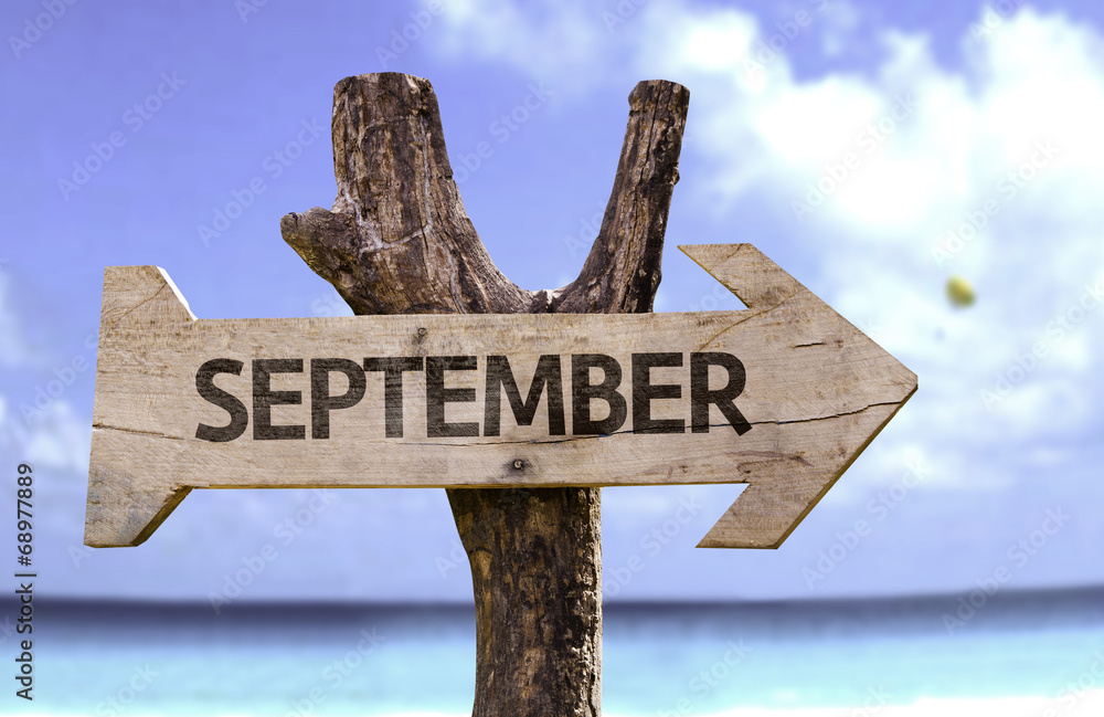September sign with a beach on background