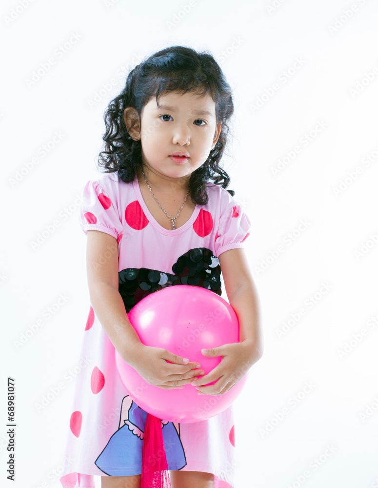 Happy asian girl playing ball on white background Happy asian girl playing ball on white background