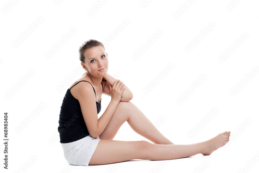 Model posing in black tank top and white shorts