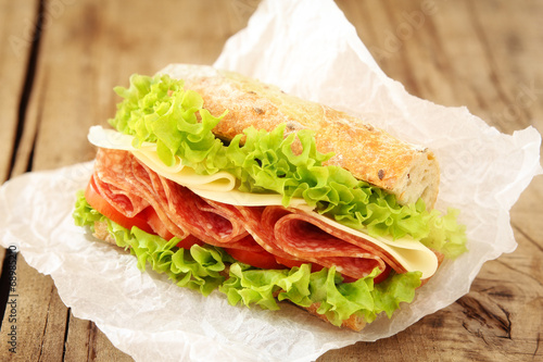 Fresh sandwich with salami, cheese, tomatoes and lettuce