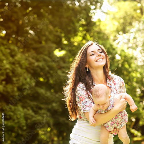 Portrait of happy loving mother and her baby outdoors