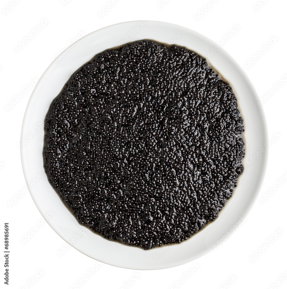 Black caviar in a white plate isolated on white Black caviar in a white plate isolated on white