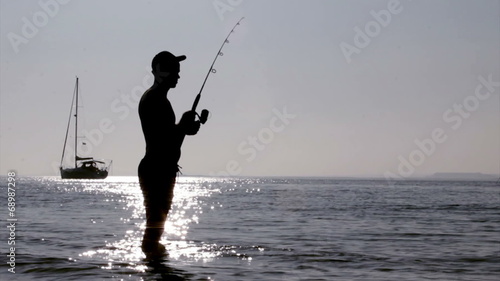 Fisherman silhouette at Ria Formosa, Algarve.