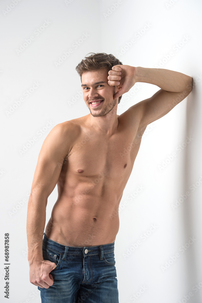 Fototapeta premium Healthy muscular young man in jeans.
