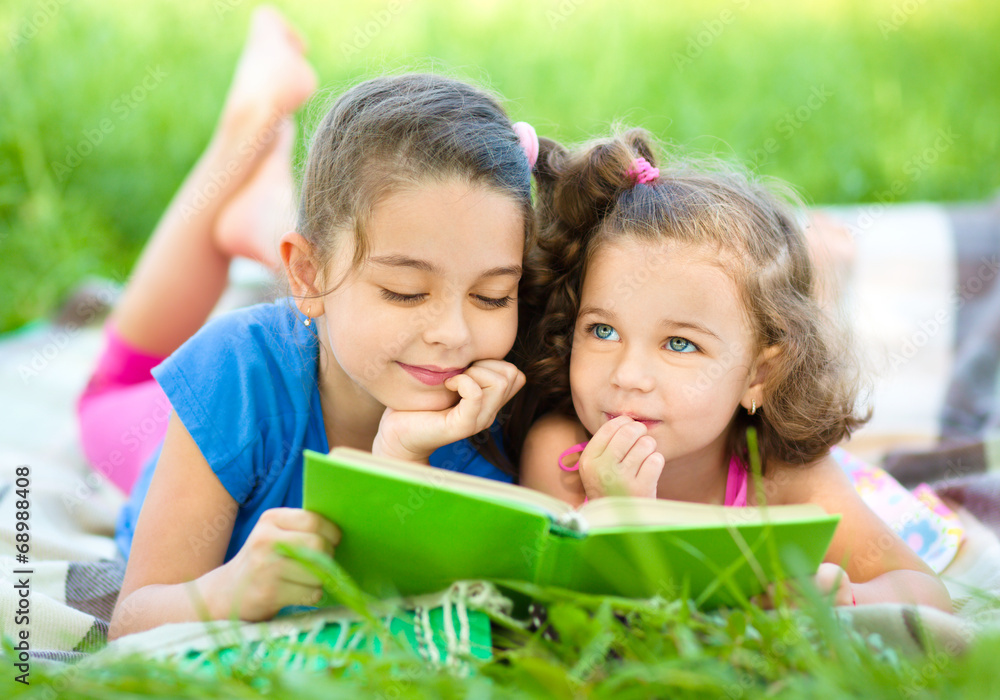 Two little girls are reading book Two little girls are reading book