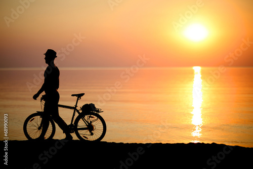 Cyclist on background of sunset, sport and rest concept