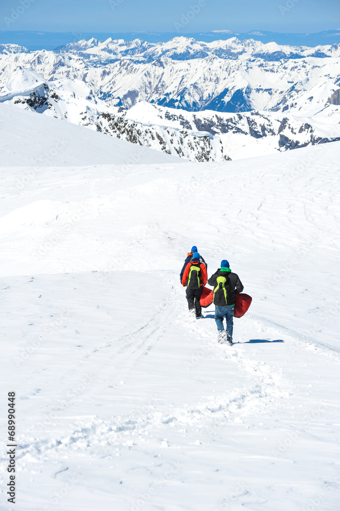 A group of mountain hiker walking on the snow into the mountain