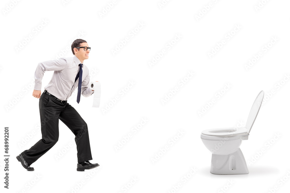 Man rushing to a urinal and holding toilet paper Man rushing to a urinal and holding toilet paper