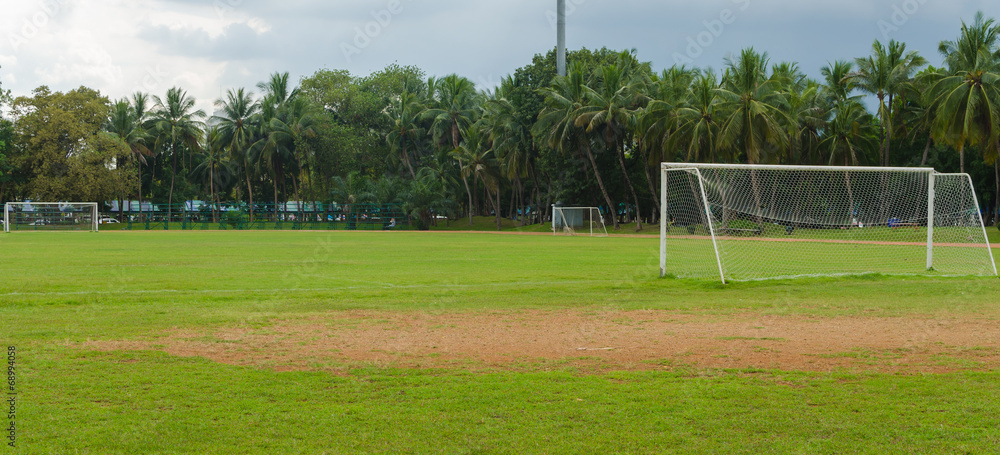 Fototapeta premium soccer goal at the end of a empty field at a park