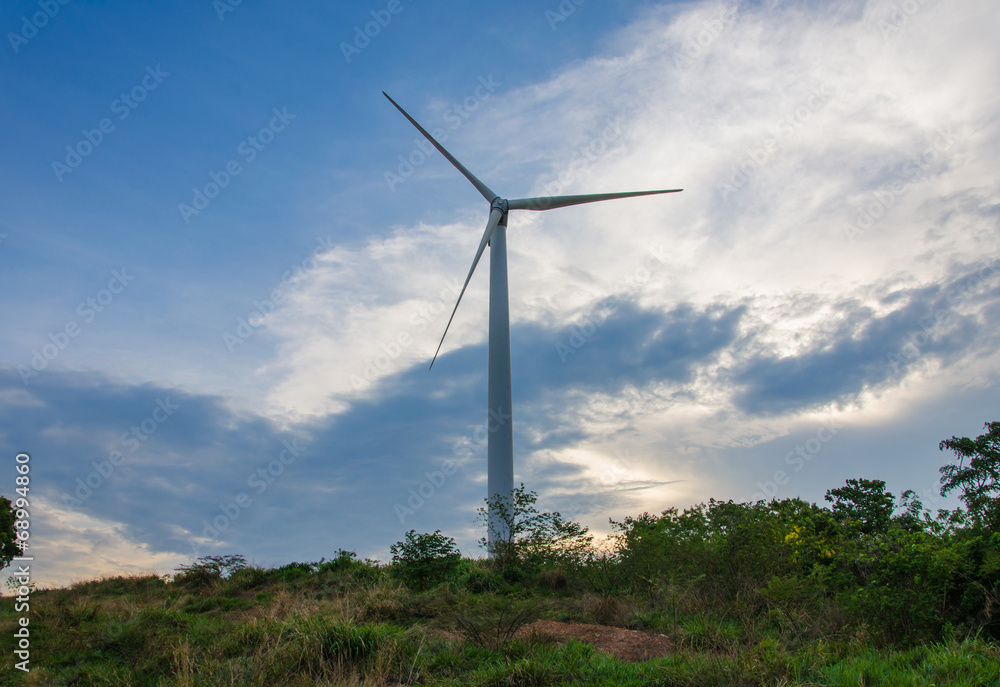 wind turbine generating electricity on hill