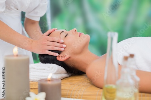 Beautiful brunette enjoying a head massage