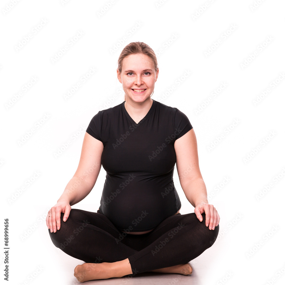 Pregnant woman exercising isolated on white