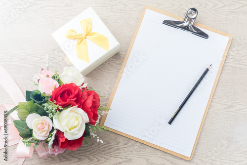 Wooden Clipboard attach planning paper with pencil beside rose b