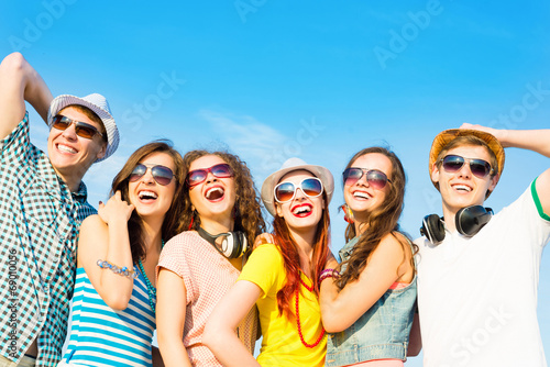 group of young people wearing sunglasses and hat © adam121