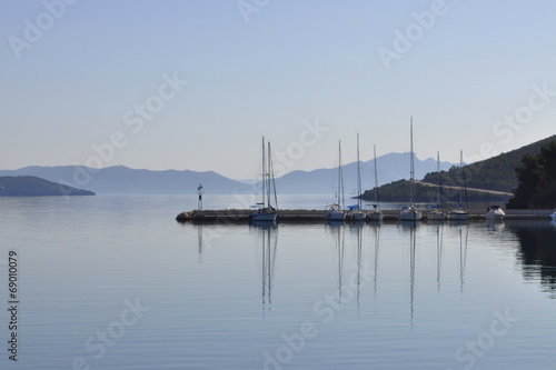 boats in a port and mountains in the distance