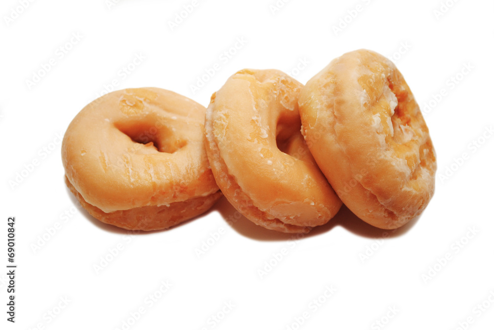 Three Glazed Doughnuts Isolated on a White Background Three Glazed Doughnuts Isolated on a White Background