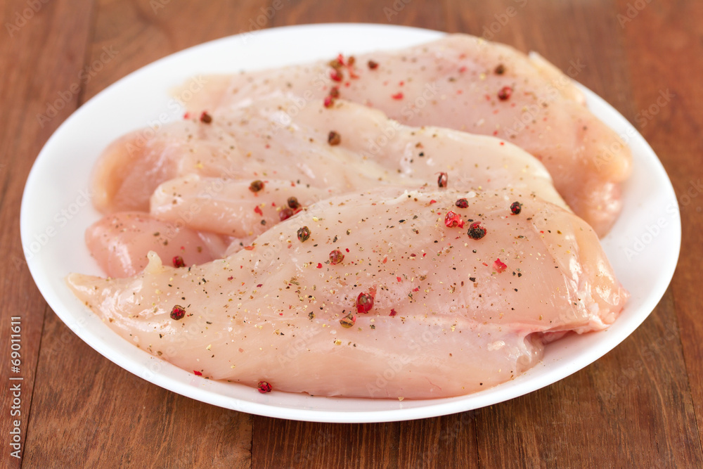 chicken breast with pepper on white plate chicken breast with pepper on white plate