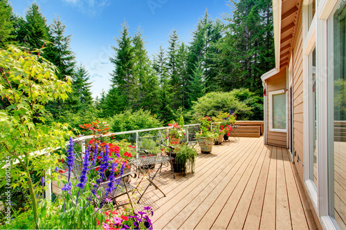 Wooden walkout deck with vibrant color flowers photo