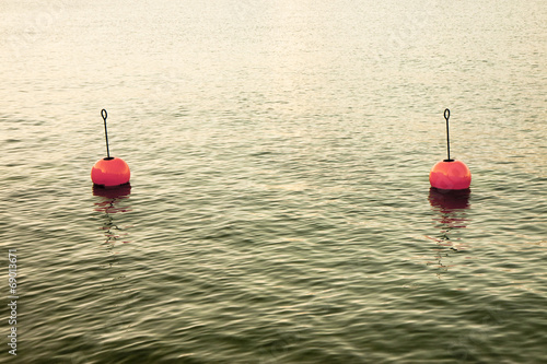 Fotografie Red bouy on a calm lake